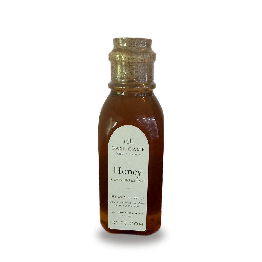 Base Camp Farm & Ranch raw & unfiltered honey, 8 oz glass muth jar with cork, on white