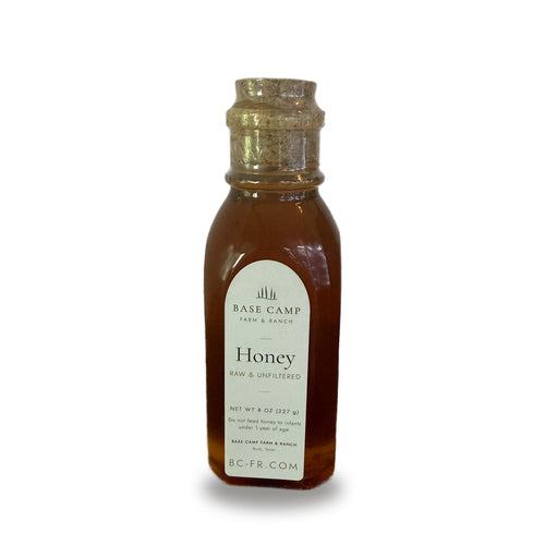 Base Camp Farm & Ranch raw & unfiltered honey, 8 oz glass muth jar with cork, on white