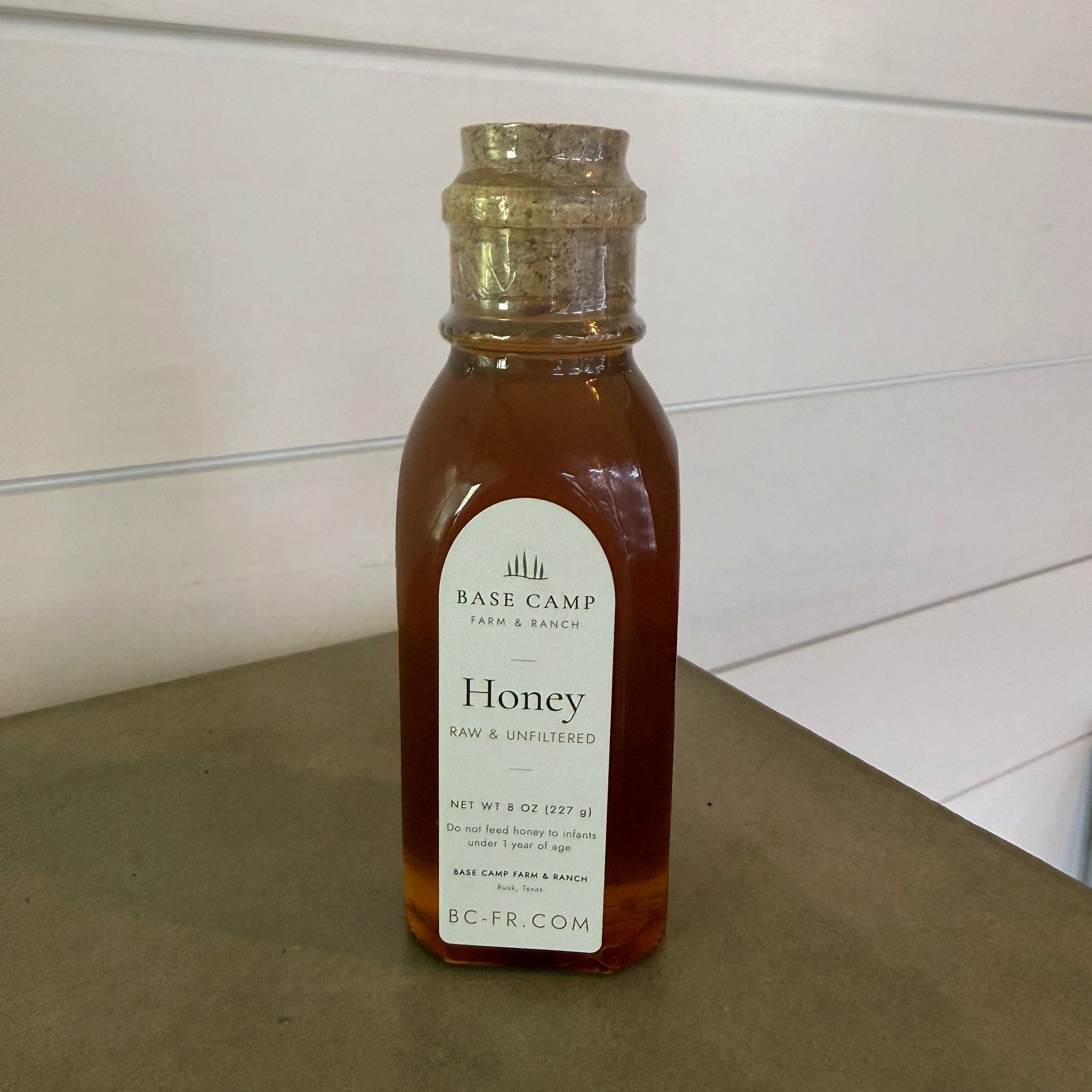 Base Camp 8 oz honey jar on the farm-stand counter